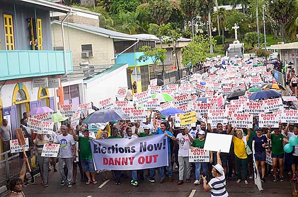 Outcry: Demonstrators display placards calling for President Danny Faure to quit