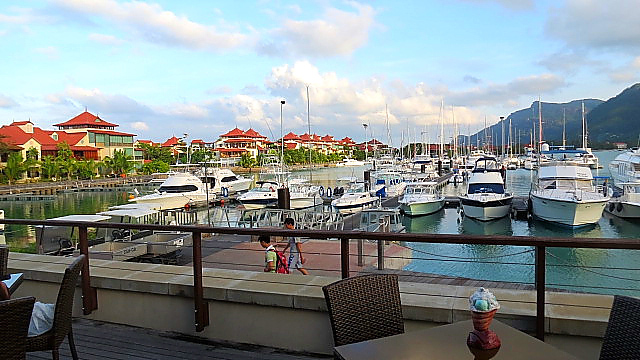Small locally-owned boats with Eden Island villas in the background