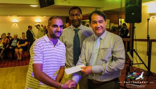GENEROSITY: Jonathan Esparon, right, with Lewis Betsy presents the £200 first prize he donated to the raffle to the lucky winner