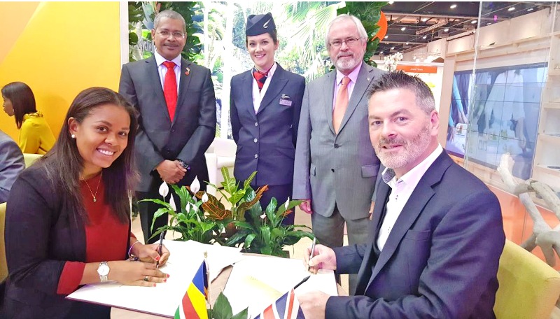 It's a deal: Tourist chief Sherin Francis, left, signs the agreement with BA's Chris Rankin watched by Derick Ally, High Commissioner to the United Kingdom, and Minister for Tourism Maurice Loustau-Lalanne