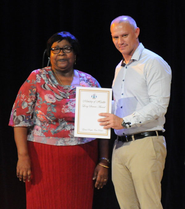 Honoured: Mariola Betsy is presented with her award by Health Minister Jean-Paul Adam