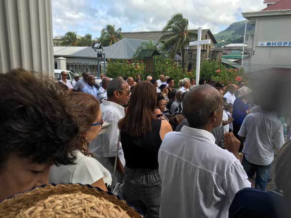 Paying their respects: Mourners outside the outside the church where the Mass was held