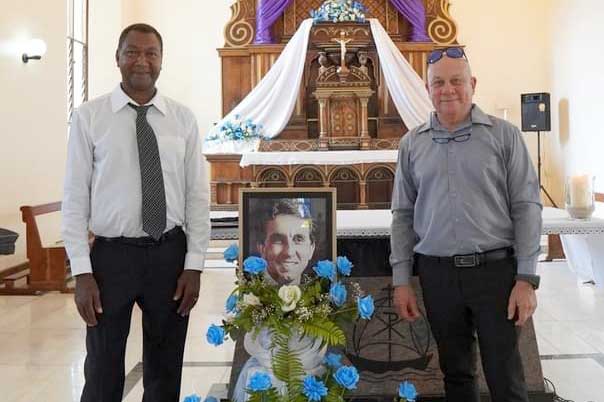 Honoured: A floral display and Gerard’s photograph with Lewis Betsy and Bernard Sullivan