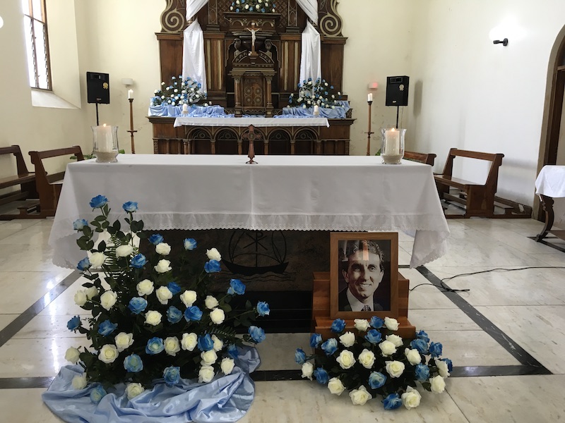 Flowers in remembrance: The altar at the Mass with a photograph of Gerard