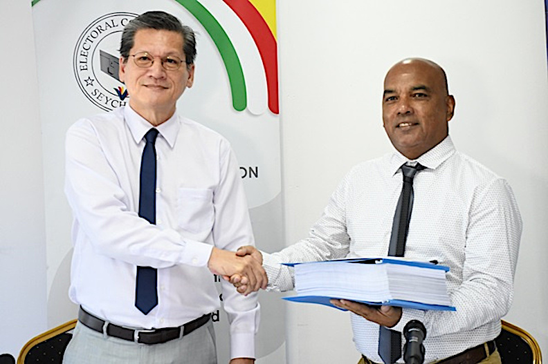 Handover: Danny Lucas, left, of the Electoral Commission presents Vincent Padayachy with his party’s registration documents (picture courtesy of Seychelles News Agency)